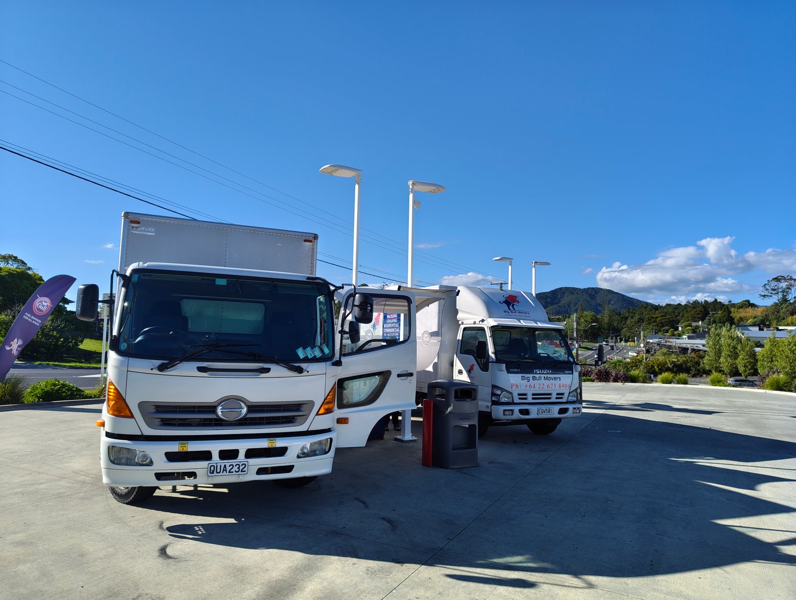 Two Big Bull Movers trucks parked in a paved forecourt during an Auckland relocation
