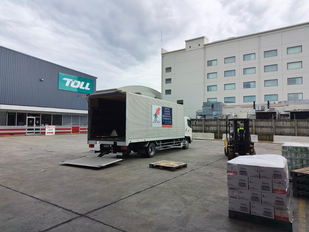 Warehouse movers Auckland – BigBull Commercial moving truck at an Auckland warehouse loading bay with pallets ready for relocation