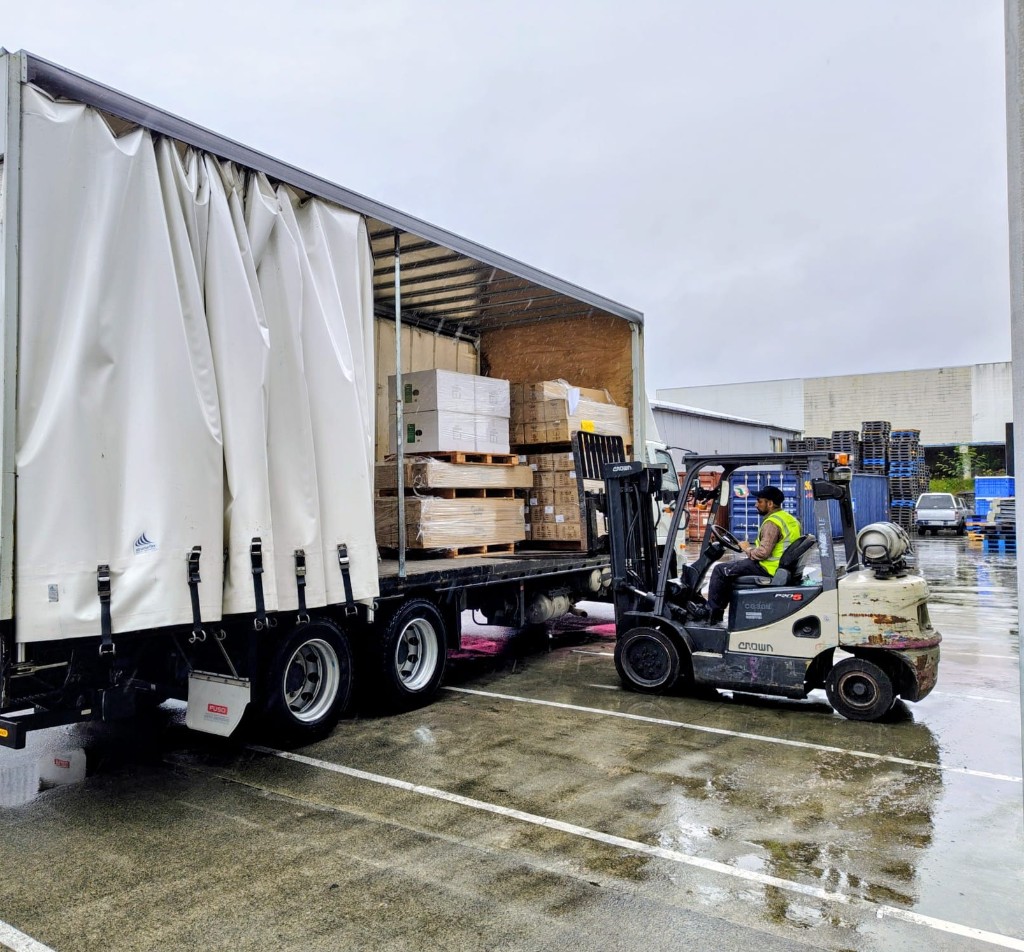 BigBull Commercial forklift operator loading pallets into a curtain-side truck during Auckland warehouse relocation